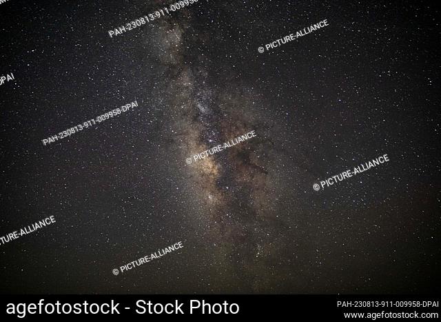 12 August 2023, Egypt, Faiyum: The Milky Way galaxy appears in the sky above the natural reserve area of Wadi Al-Hitan (Valley of the Whales) at the desert of...