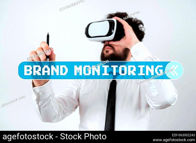 Hand writing sign Brand Monitoring, Word for security to web browsers in order to protect networked data Standig Man Holding Pen To Point Important Messages And...