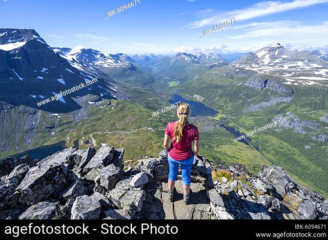 Hiker looking from the top of Innerdalstårnet, Innerdalen high valley with lake Innerdalsvatna, Trollheimen Mountain Area, Sunndal, Møre og Romsdal, Vestlandet