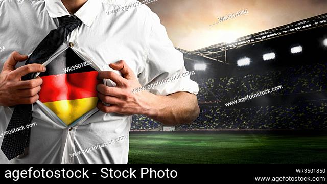 Germany soccer or football supporter showing flag under his business shirt on stadium
