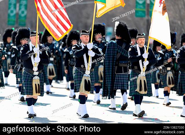 Chicago, Illinois, USA - March 16, 2019: St. Patrick's Day Parade, The Bagpipes and Drums of the Emerald Society Chicago Police Department performing at the...