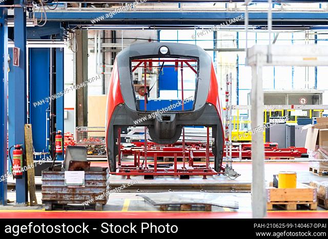 10 June 2021, North Rhine-Westphalia, Krefeld: A front cover of a Deutsche Bahn regional train stands in a large maintenance hall