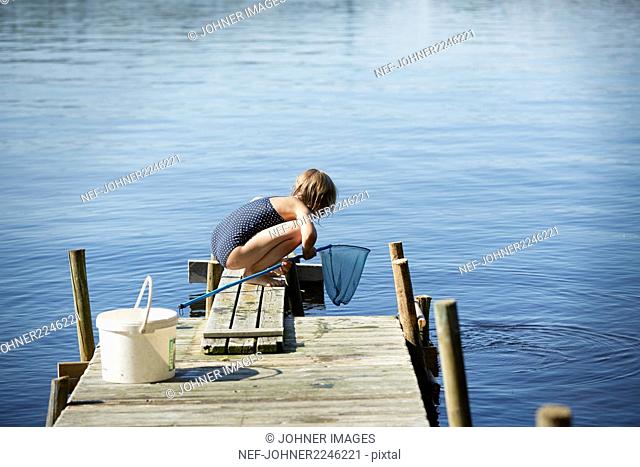 Girl fishing on jetty