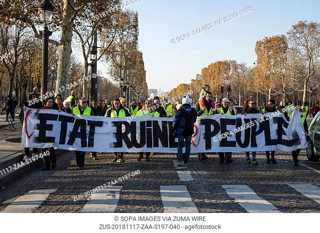 November 17, 2018 - Paris, Ile de France, France - Protesters wearing yellow vests are seen holding a banner during the protest
