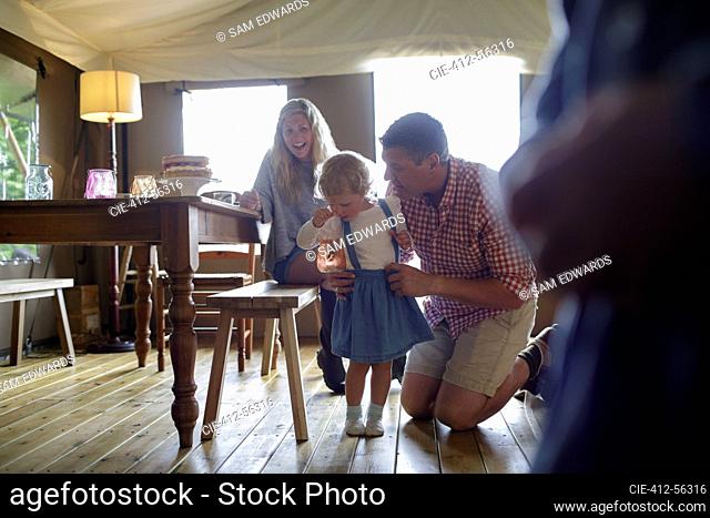 Happy family at dining table in yurt cabin