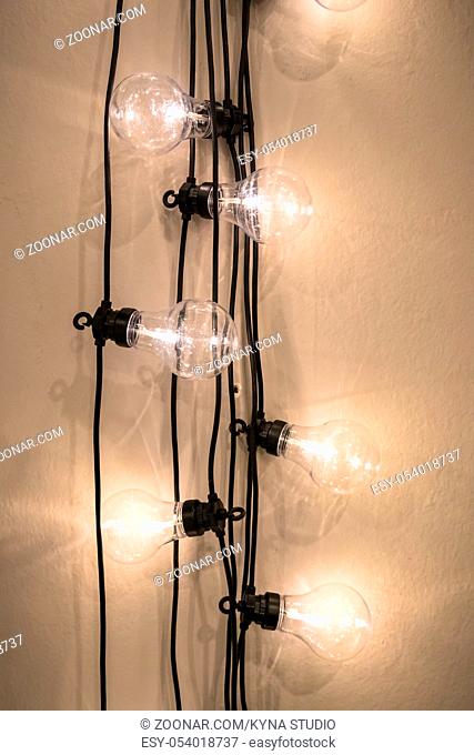 Decorative light bulbs against wall background