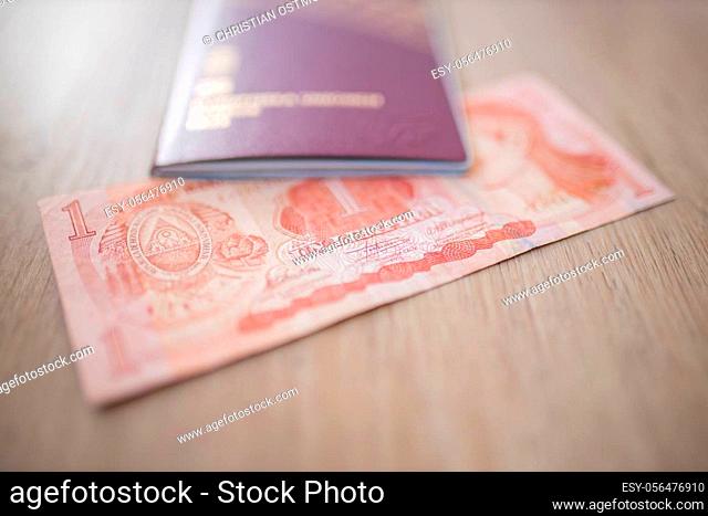 Picture of a Swedish Passport on top of a Blurry Honduran Lempira Bill