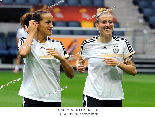Germany's Fatmire Bajramaj (L) and Anja Mittag take part in a training session at Friends Arena in Solnar,  Sweden, 27 July 2013