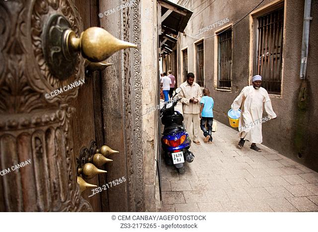 Scene from the alleys of town center with an old door at side, Stone Town, Zanzibar Island, Tanzania, East Africa