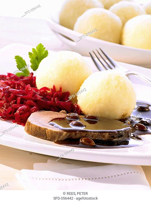 Rhineland-style Sauerbraten marinated pot roast with red cabbage and dumplings