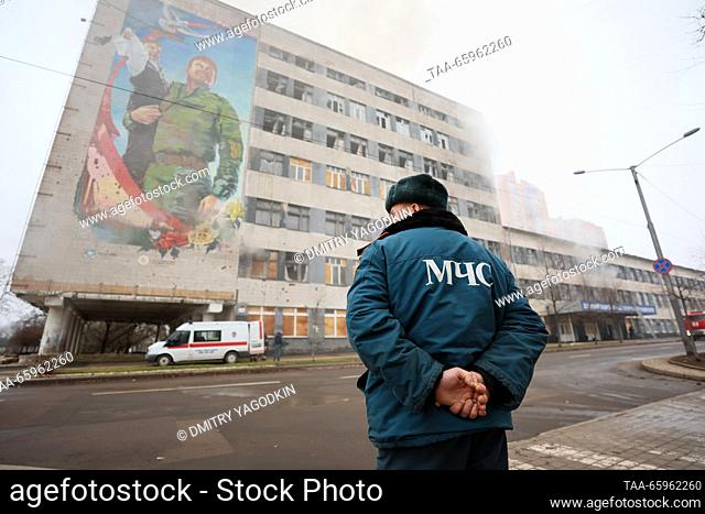 RUSSIA, DONETSK - DECEMBER 21, 2023: An employee of Russia's Emercom stands before the fire-hit Building 3 of the Donetsk National Technical University after a...