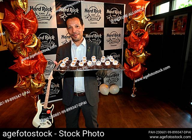 30 May 2023, North Rhine-Westphalia, Cologne: Hard Rock Cafe Cologne turns 20 this year. General Manager Uriel Santiago with anniversary chocolate brownies...