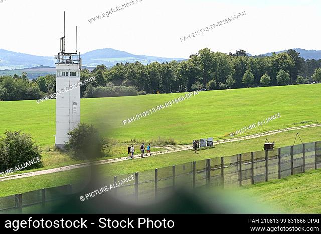 13 August 2021, Thuringia, Geisa: View of a former observation tower behind a border fence at the Point Alpha memorial site