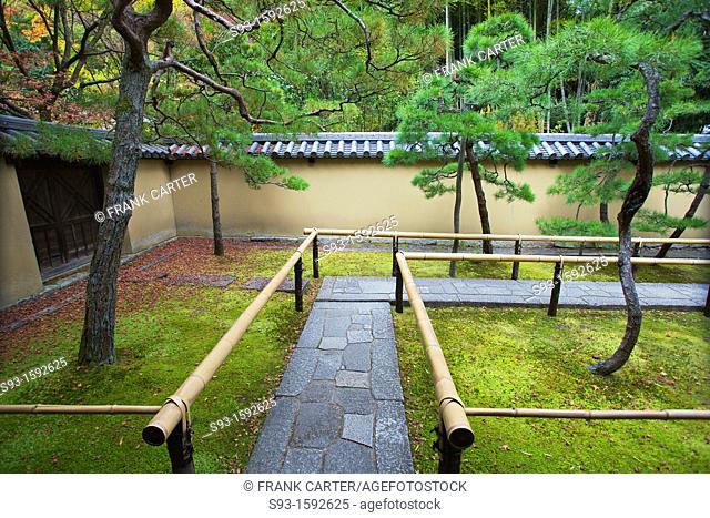 A view of a small temple walkway through moss covered grounds at Daitokuji temple