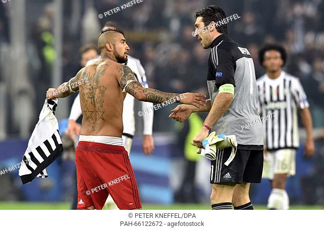 Munich's Arturo Vidal (L) talks to Juve's Gianluigi Buffon after the UEFA Champions League round of 16 first leg soccer match between Juventus Turin and FC...