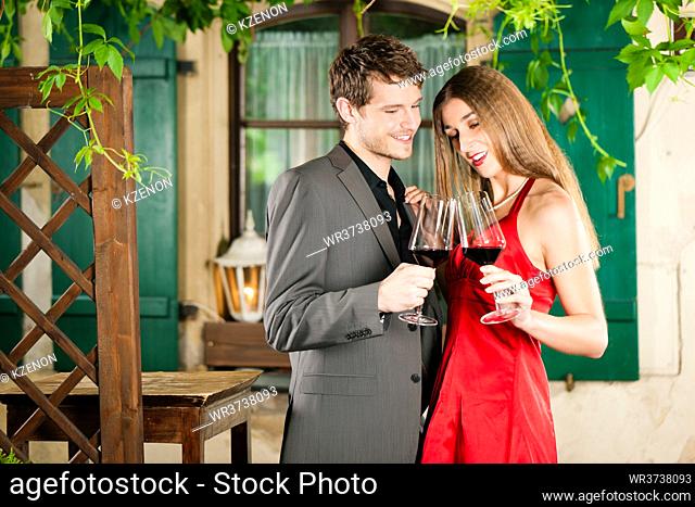 Couple at winetasting with red wine in a restaurant