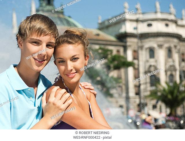 Germany, Munich, Karlsplatz, Young man and woman smiling, portrait