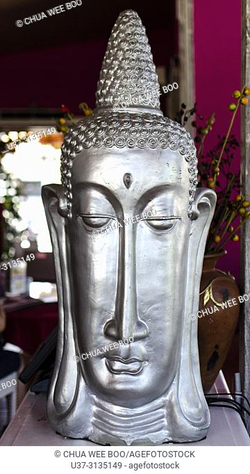 Silver Budhha face placed at a restaurant in Seminyak Street, Bali