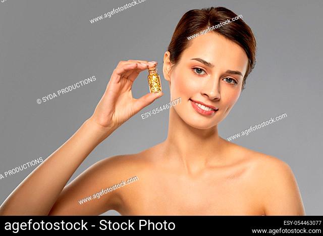 beautiful young woman with gold facial mask