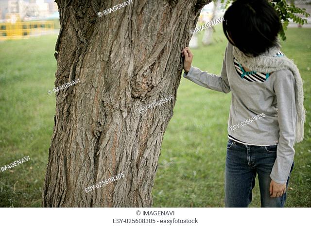 Young woman and tree
