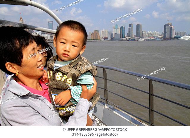 China, Shanghai, Huangpu River, Jinling East Road Dongchang Road Ferry, passengers, Asian, grandmother, woman, boy, grandson, holding, deck