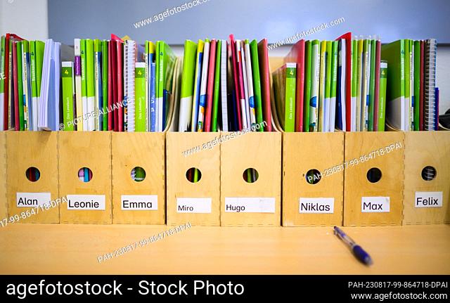 17 August 2023, Lower Saxony, Hanover: Wooden folders with teaching materials and textbooks stand in the classroom of a 4th grade class at an elementary school...