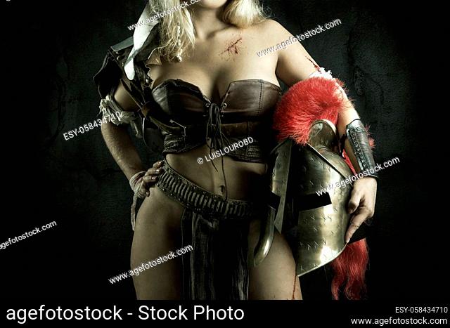 Ancient woman warrior or Gladiator body part, against a dark background