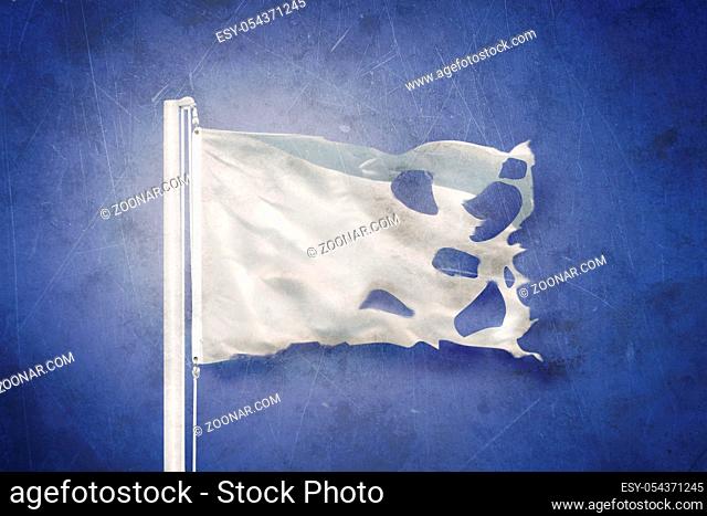 Torn White flag flying against grunge background