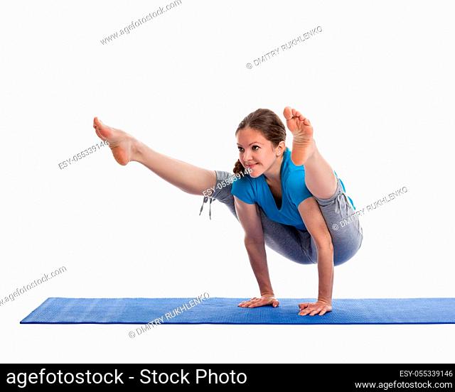 Yoga - young beautiful woman yoga instructor doing Firefly asana pose (Titibasana) exercise isolated on white background