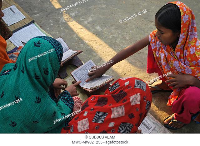 Children learn to read the Holy Quran early in the morning at the yard of a home in rural Gaibandha It is common in rural area that the children take Arabic and...