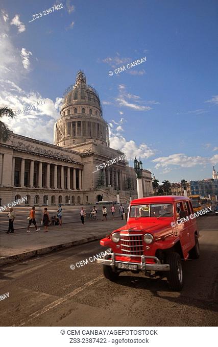 Street scene of old American cars used as taxis in front of the Capitolio building in Central Havana, Cuba, West Indies, Central America