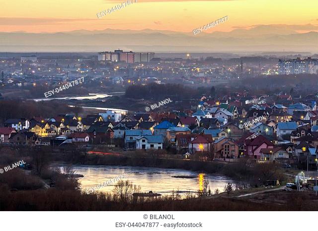 Aerial evening view Ivano Frankivsk city, Ukraine. Splendid sunset in big city with residential area with privane houses