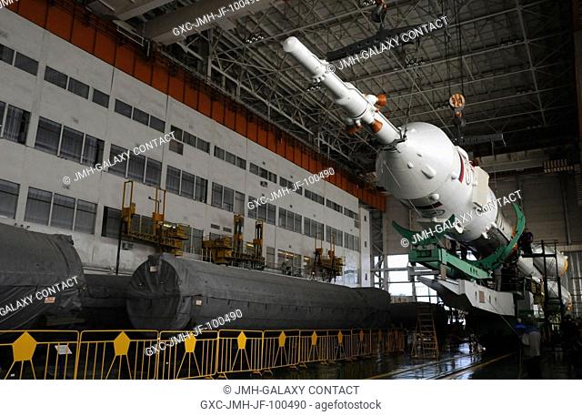 At the Integration Facility at the Baikonur Cosmodrome in Kazakhstan, the upper stage of the Soyuz booster rocket containing the Soyuz TMA-03M spacecraft is...