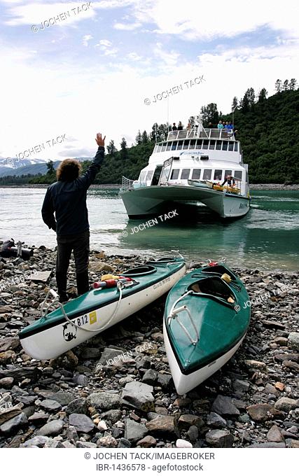 Man with kayaks waiting for transport by ferry, Ranger Station, Glacier Bay National Park, Alaska, USA