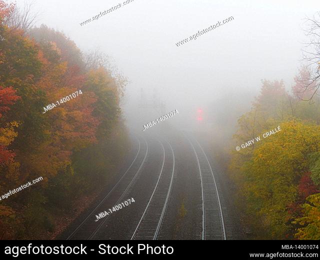 autumn season in canada, ontario, morning fog, rail lines, 3 railway tracks, signal lights, the unknown