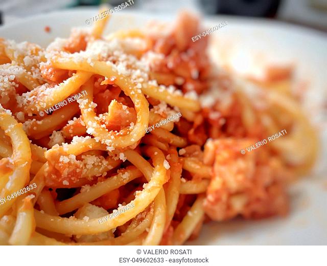 Homemade pasta bucatini amatriciana with tomato sauce and cured pork cheek and pecorino cheese