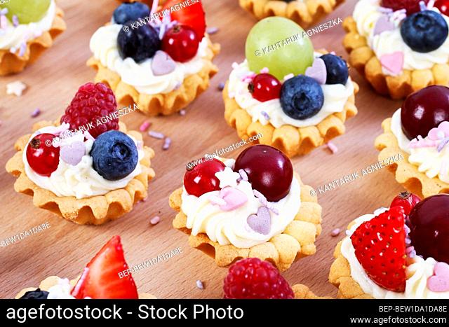 Colorful cupcakes with fresh fruits. Party dessert
