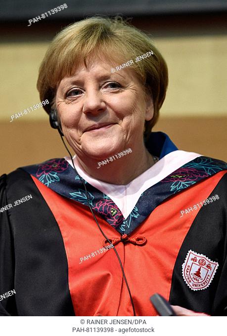German Chancellor Angela Merkel receives an honorary doctorate from the University of Nanjing at the University of the Chinese Academy of Sciences (UCAS) in...
