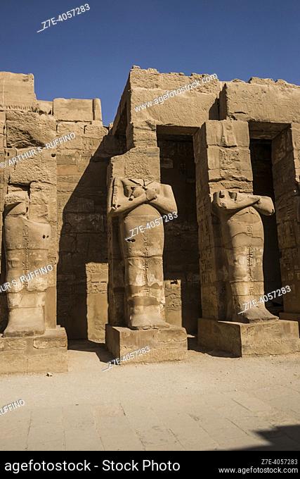 Osiride pillars with statues of Ramses III. Court/Temple of Ramses III. Temple of Karnak. El-Karnak, Luxor Governorate, Egypt, Africa, Middle East