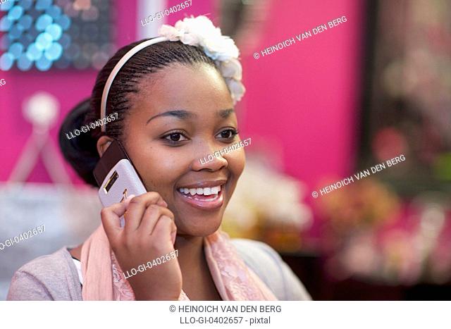 A young woman using her cellphone, Pietermaritzburg, KwaZulu-Natal, South Africa