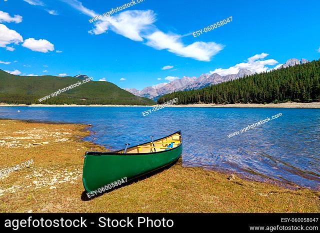 Green Canoe on the shore of a mountain lake, Peter Lougheed provincial Park, Alberta