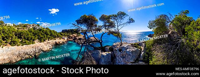 Spain, Mallorca, Santanyi, Helicopter view of bay surrounded by steep coastal cliffs in summer