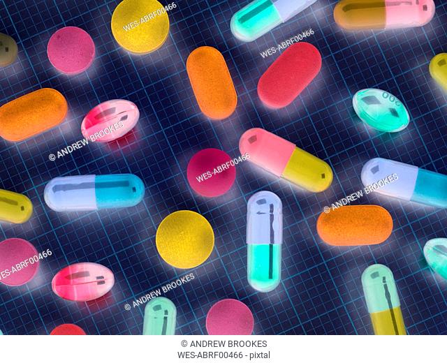 High angle view of various medicines on graph paper