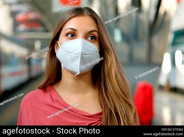 Close up of girl waiting metro wearing protective face mask at subway station