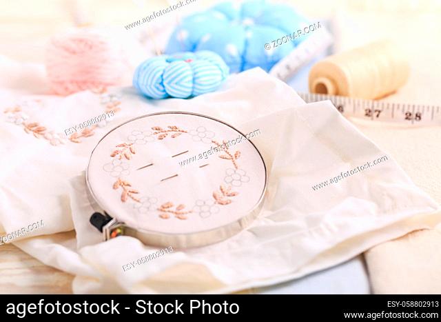 Canvas for embroidery in a round hoop, multi-colored thread mouline thread and other supplies for needlework. Hobby, crafting, creativity
