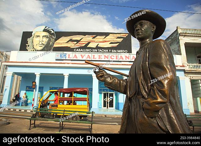 Coco taxi in front of the colonial buildings at Paseo Del Prado or so-called Boulevard with the famous Cuban compositor and musician Benny More's statue in the...