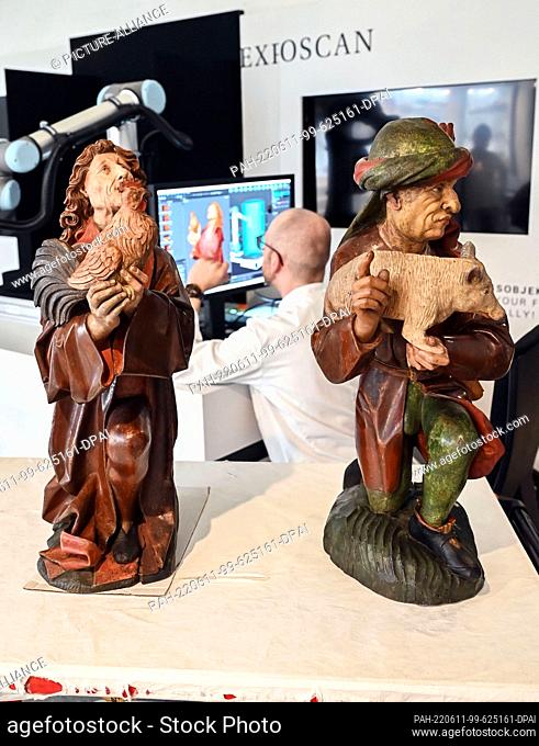 PRODUCTION - 10 June 2022, Baden-Wuerttemberg, Karlsruhe: In the Baden State Museum, the late medieval wooden sculptures ""Gabenbringer mit Hahn"" (l) and...