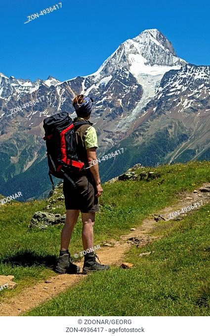 Hiker on a hike in the Loetschental valley