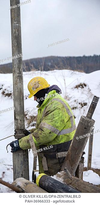 A worker prepares a drill head to drill for samples at a mine dump in Altenberg,  Germany, 11 February 2013. The Helmholtz Research Center in Dresden and the...