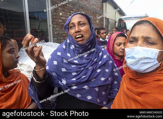People are seen crying after family members died and got injured in a deadly fire that broke out at a food factory in Narayanganj's Rupganj